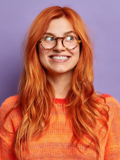 positive-facial-expressions-happy-smiling-woman-with-natural-red-hair-looks-away-and-smiles-broadly-e1627313240340.jpg
